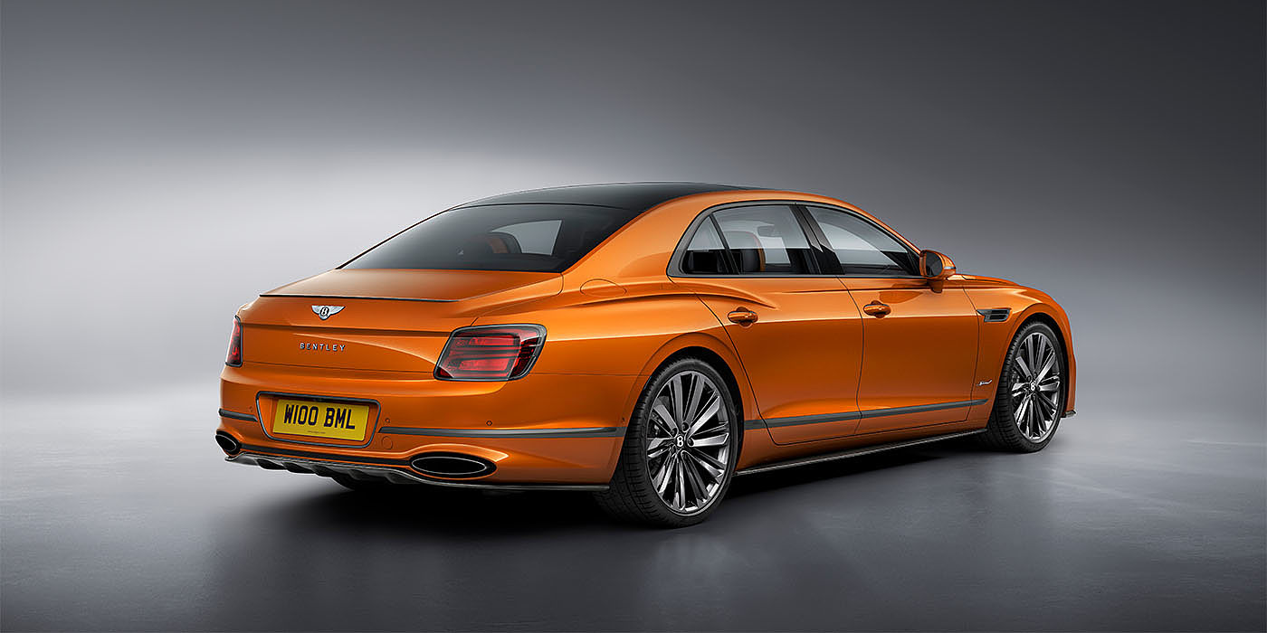 Bach Premium Cars GmbH | Bentley Mannheim Bentley Flying Spur Speed in Orange Flame colour rear view, featuring Bentley insignia and enhanced exhaust muffler.