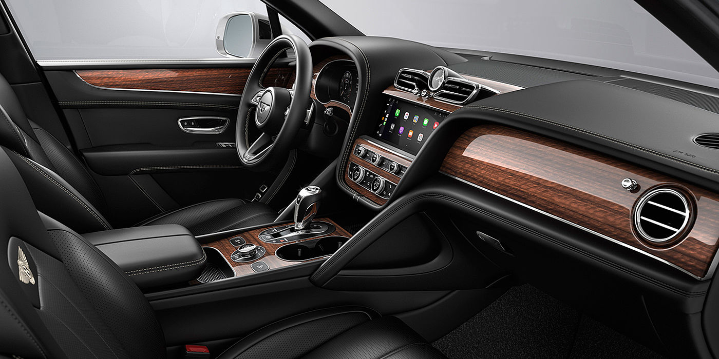 Bach Premium Cars GmbH | Bentley Mannheim Bentley Bentayga interior with a Crown Cut Walnut veneer, view from the passenger seat over looking the driver's seat.