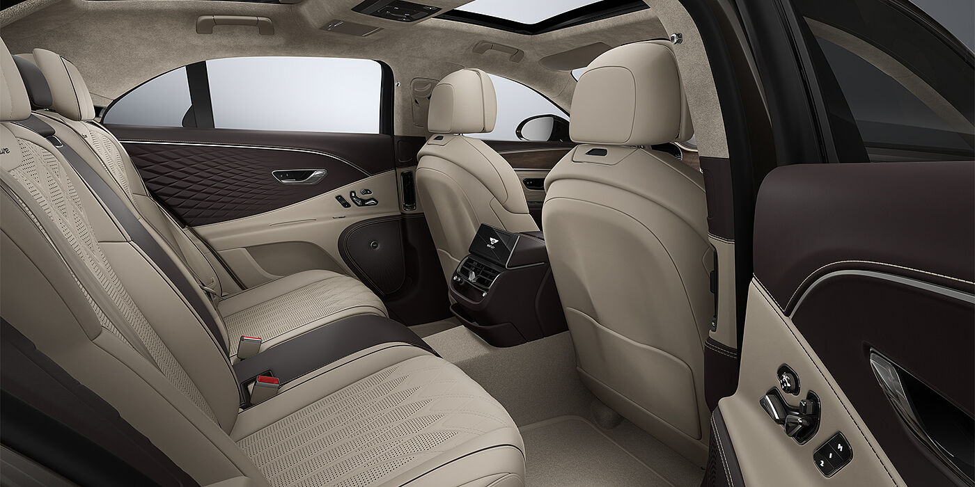Bentley Mannheim New Bentley Flying Spur Azure sedan rear interior in Portland and Burnt Oak hides with Open Pore Crown Cut Walnut veneer