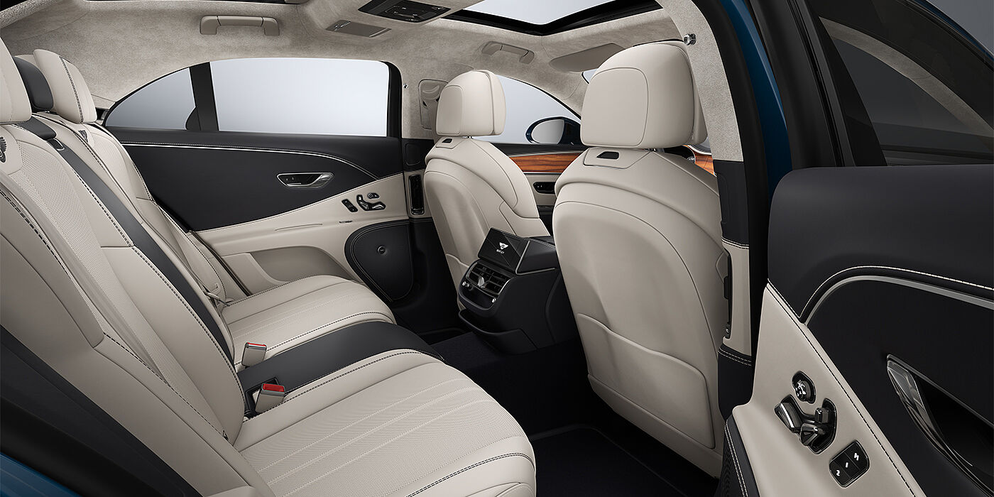 Bentley Mannheim New Bentley Flying Spur sedan rear interior in Linen and Imperial Blue hides with Open Pore Koa veneer