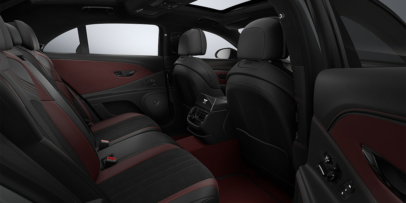Bentley Mannheim New Bentley Flying Spur S sedan rear interior in Cricket Ball red and Beluga black hides with High Gloss Carbon Fibre veneer