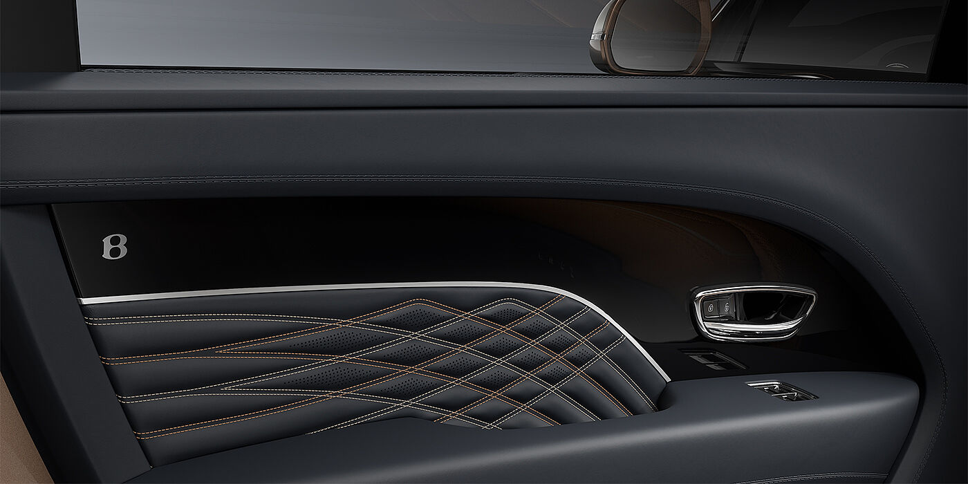 Bentley Mannheim Bentley Bentayga EWB Mulliner SUV door interior detail in Brunel hide and Grand Black veneer with Mulliner contrast stitching