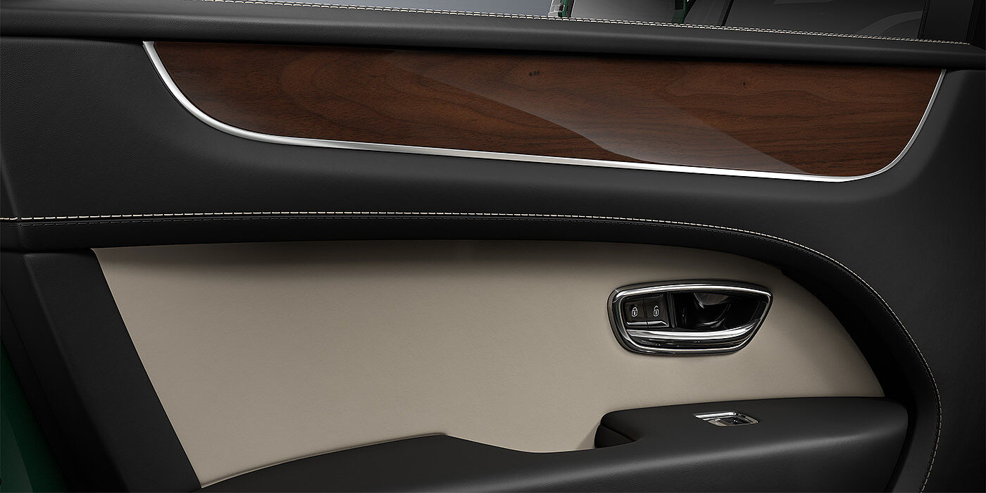 Bentley Mannheim Bentley Bentayga SUV door interior detail in Portland and Beluga black hides with Crown Cut Walnut veneer