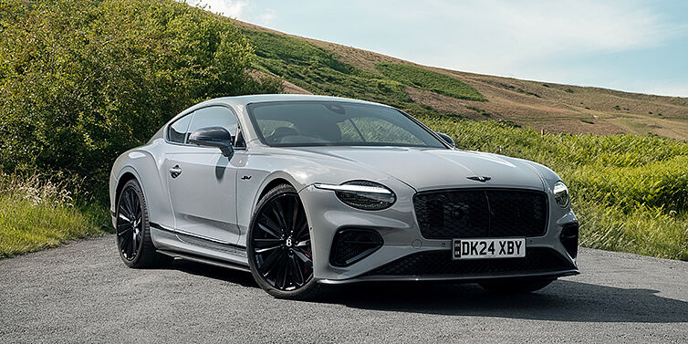 Bach Premium Cars GmbH | Bentley Mannheim Bentley Continental GT front three quarter with Carbon Fibre Specification parked on road.