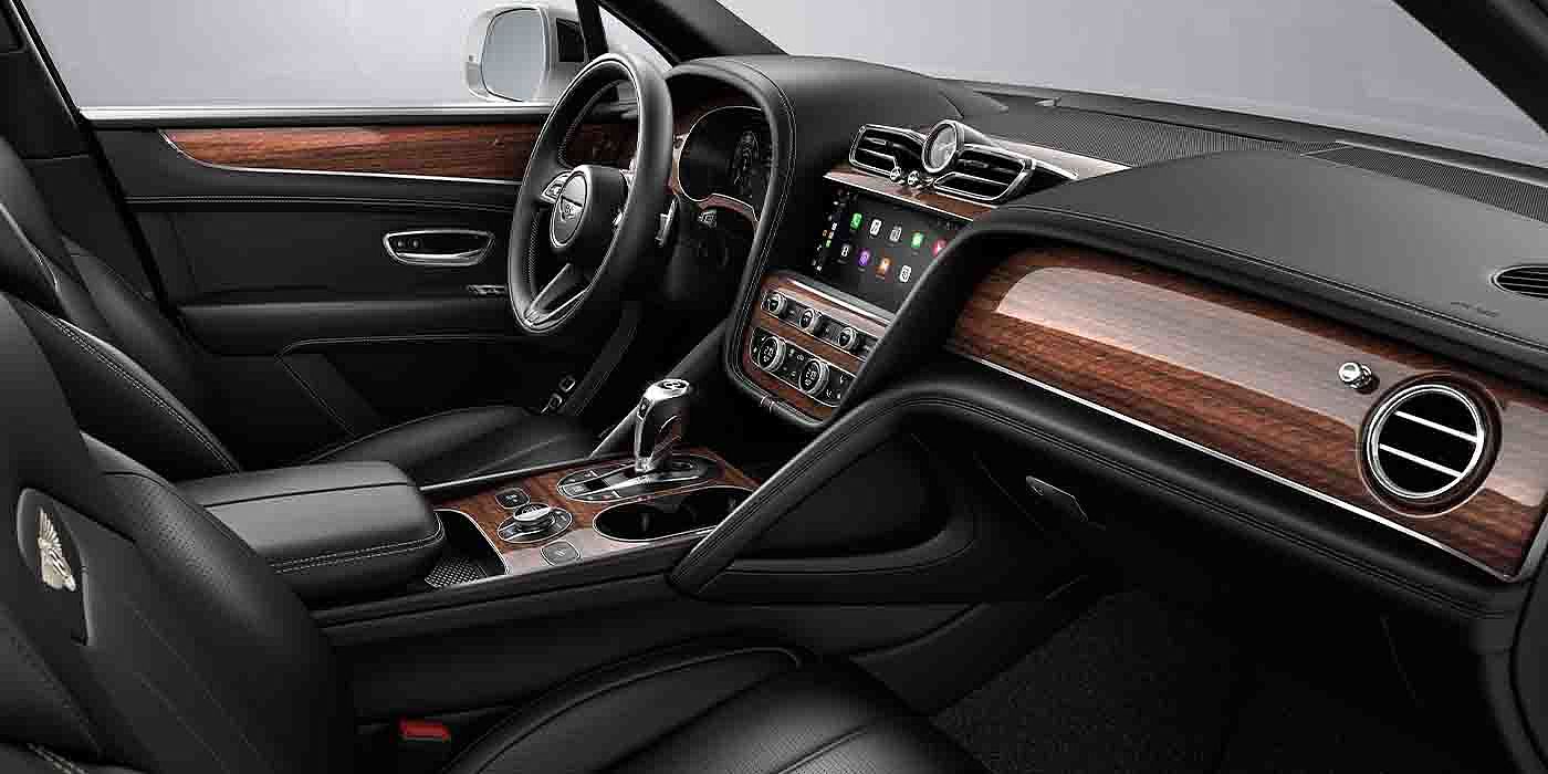 Bach Premium Cars GmbH | Bentley Mannheim Bentley Bentayga EWB interior with a Crown Cut Walnut veneer, view from the passenger seat over looking the driver's seat.