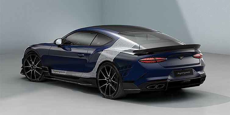 Bach Premium Cars GmbH | Bentley Mannheim Bentley Supersports rear three quarter in "Skies" Design theme with Electric Blue paint finish and Arctica white and Oxford blue paint stripes across the rear haunch.