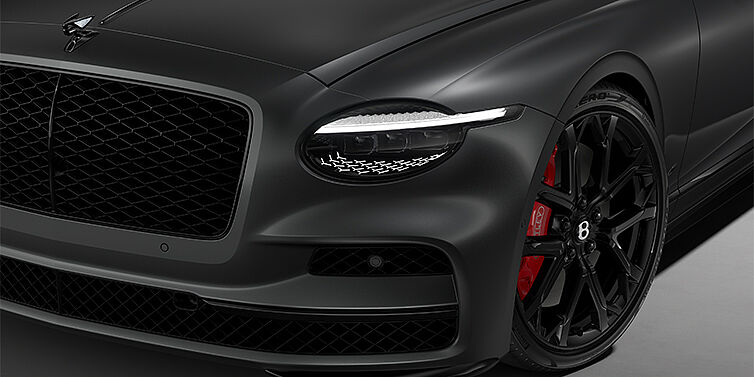 Bentley Mannheim New Bentley Flying Spur S sedan head lamp against Anthracite Satin paint with 22" Sports wheel