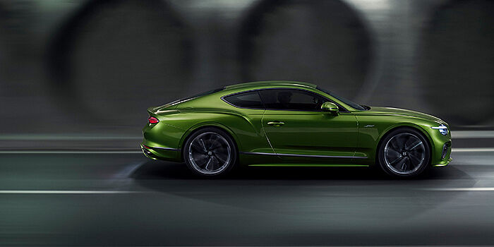  Bach Premium Cars GmbH | Bentley Mannheim Bentley Continental GT coupe in Tourmaline Green paint driving in profile on a dark road