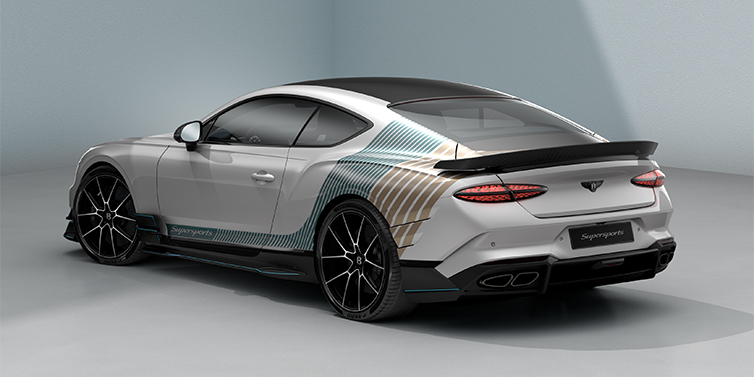 Bach Premium Cars GmbH | Bentley Mannheim Bentley Supersports rear three quarter in "Snowstorm" Design theme with Snow Quartz paint and Topaz blue and Camel brown paint stripes across the rear haunch.