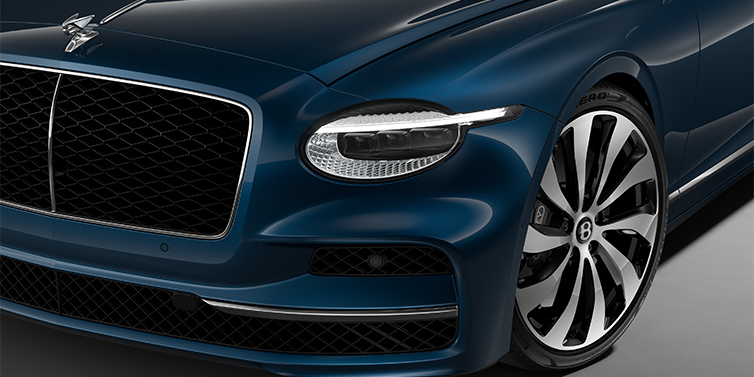 Bentley Mannheim New Bentley Flying Spur sedan head lamp against Marlin blue paint with 22" Ten Spoke Black Painted and Bright Machined wheel