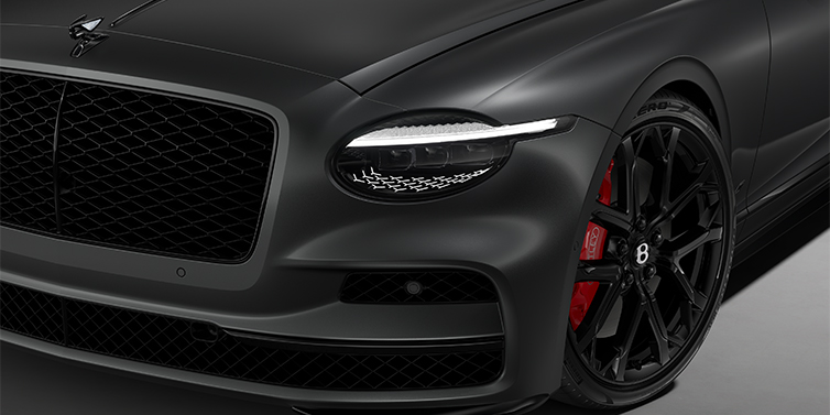 Bentley Mannheim New Bentley Flying Spur S sedan head lamp against Anthracite Satin paint with 22" Sports wheel