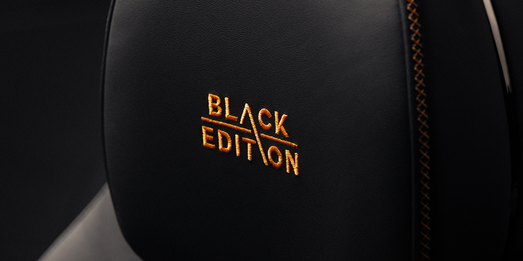 Bach Premium Cars GmbH | Bentley Mannheim Bentley Continental GT coupe seat headrest Black Edition stitched emblem in Mandarin colour against Beluga black hide