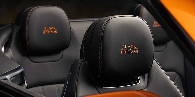 Bach Premium Cars GmbH | Bentley Mannheim Bentley Continental GTC Black Edition convertible seat detail with Beluga black hide and Mandarin emblem stitching
