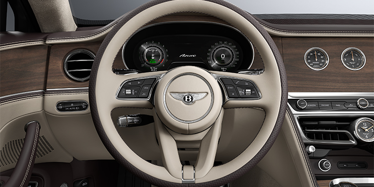 Bentley Mannheim New Bentley Flying Spur Azure sedan steering wheel and dash in Portland and Burnt Oak hides and Open Pore Crown Cut Walnut veneer
